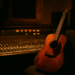 Ruang kontrol studio rekaman dengan konsol mixing dan gitar akustik sebagai ilustrasi film biopik musik